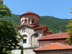 Exterior view of Bachkovo Monastery showcasing traditional Bulgarian Orthodox architecture with stone walls, arches, and red-tiled roofs